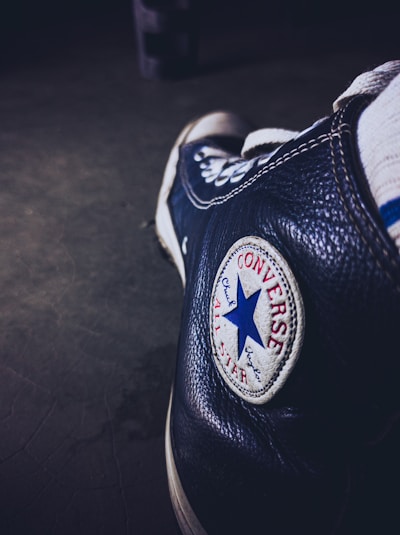 Close-up of a Converse shoe customized with intricate mandala patterns in black and white.