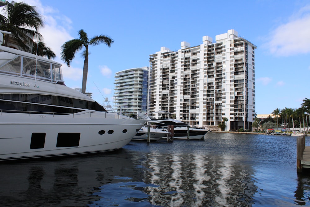 a large white boat sitting next to a tall white building