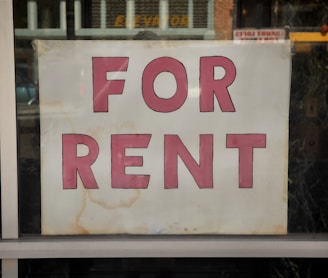 a for rent sign in a store window