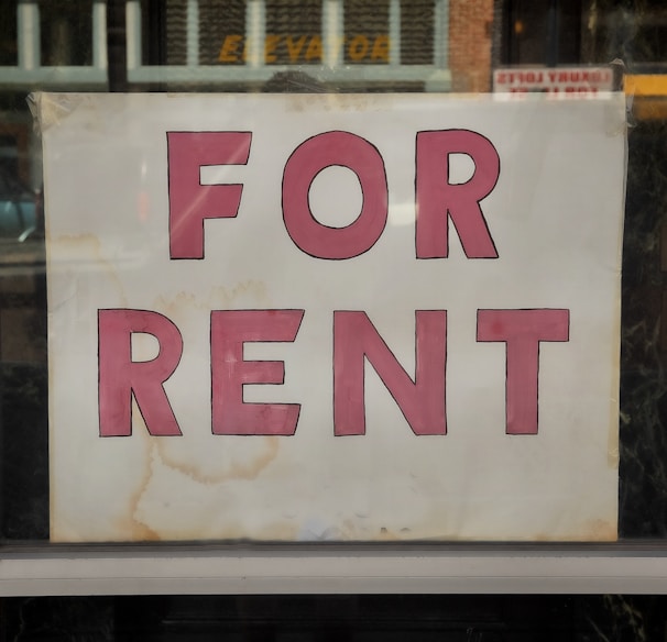 a for rent sign in a store window