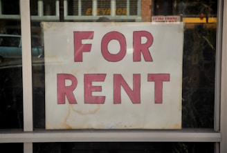 a for rent sign in a store window