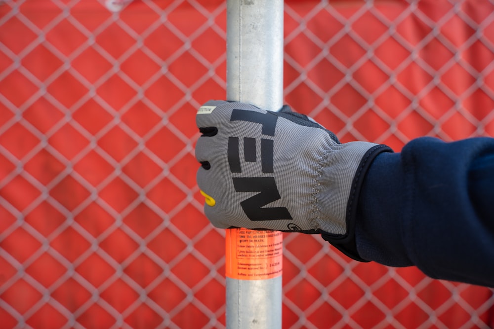 a person wearing a glove is holding a pole