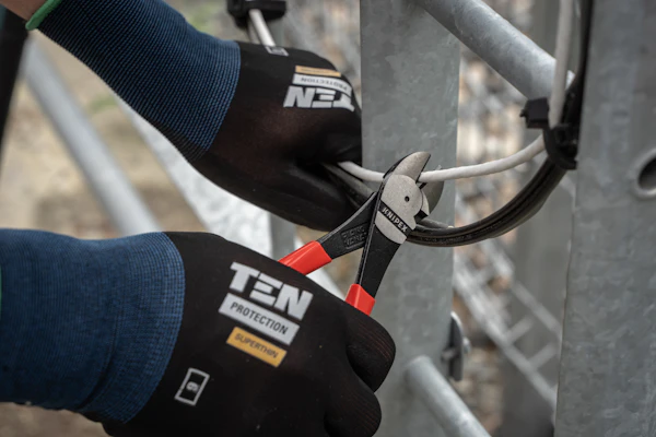 Hands using pliers for a home repair
