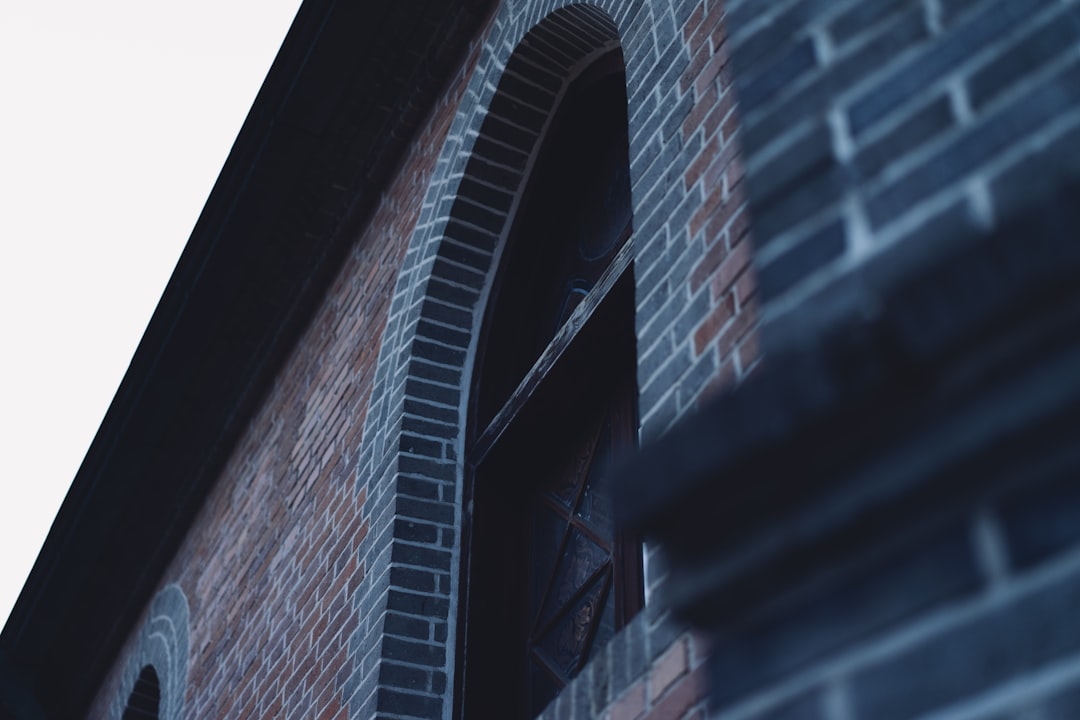 a brick building with a clock on the side of it,