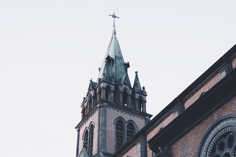 a church steeple with a cross on top