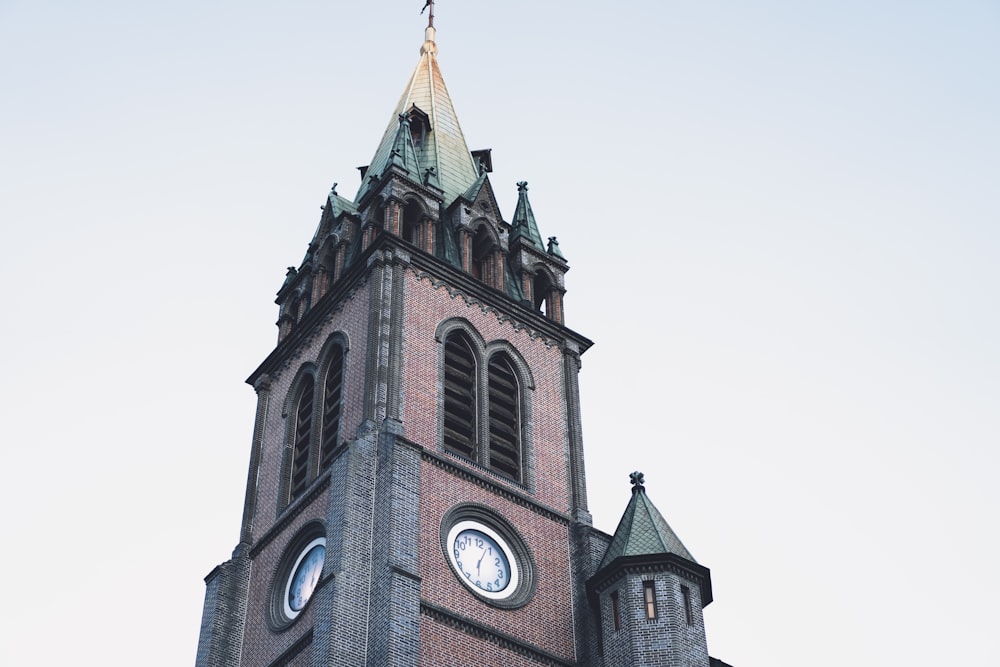 a tall tower with a clock on the top of it