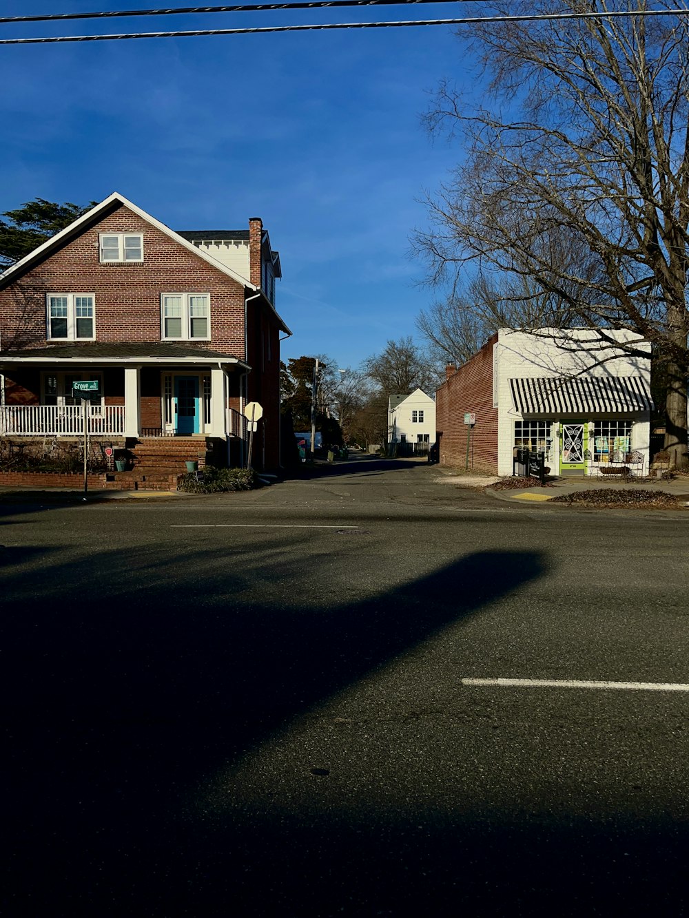 a street corner with a house and a tree