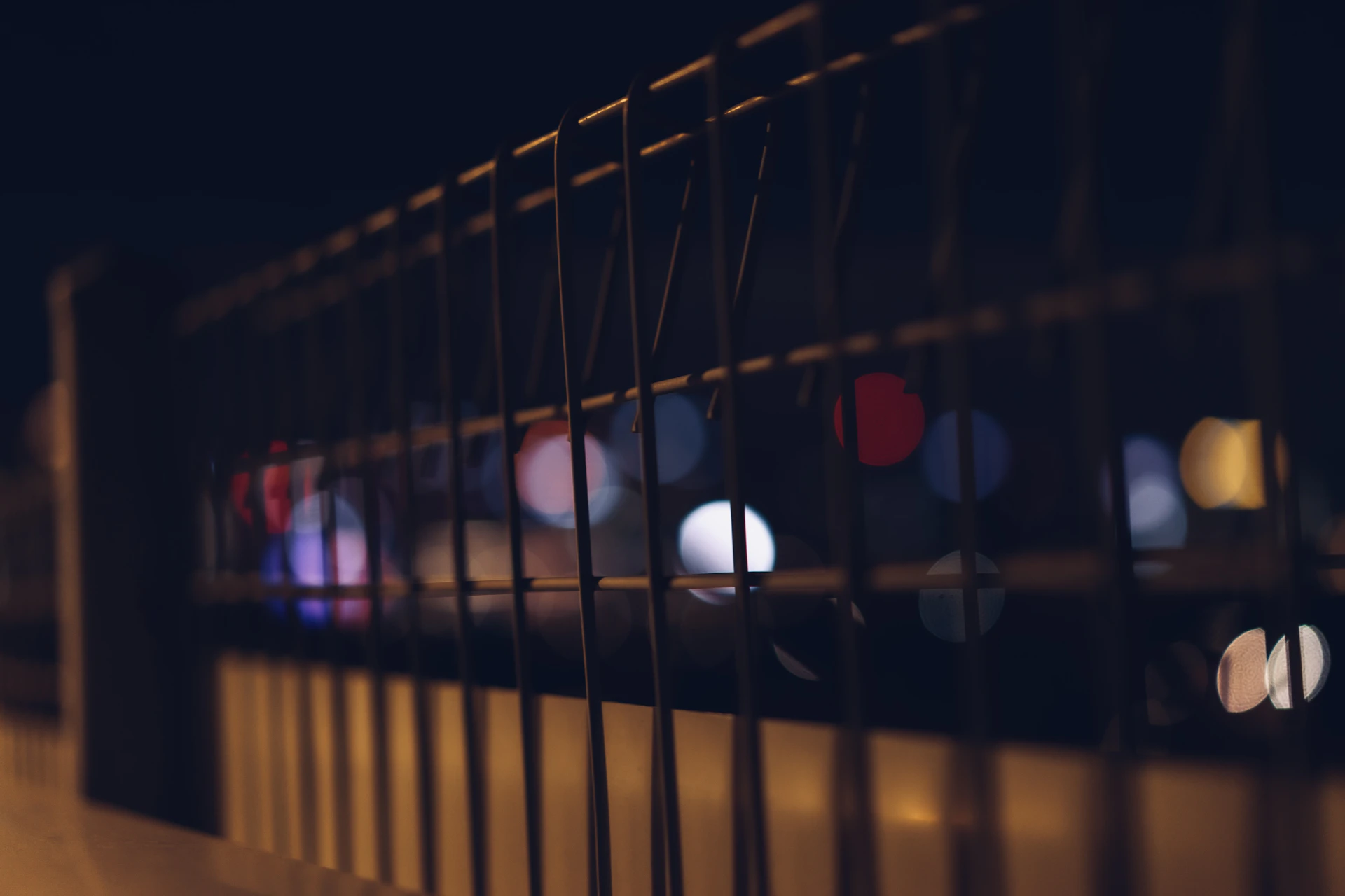 a blurry photo of a fence and street lights