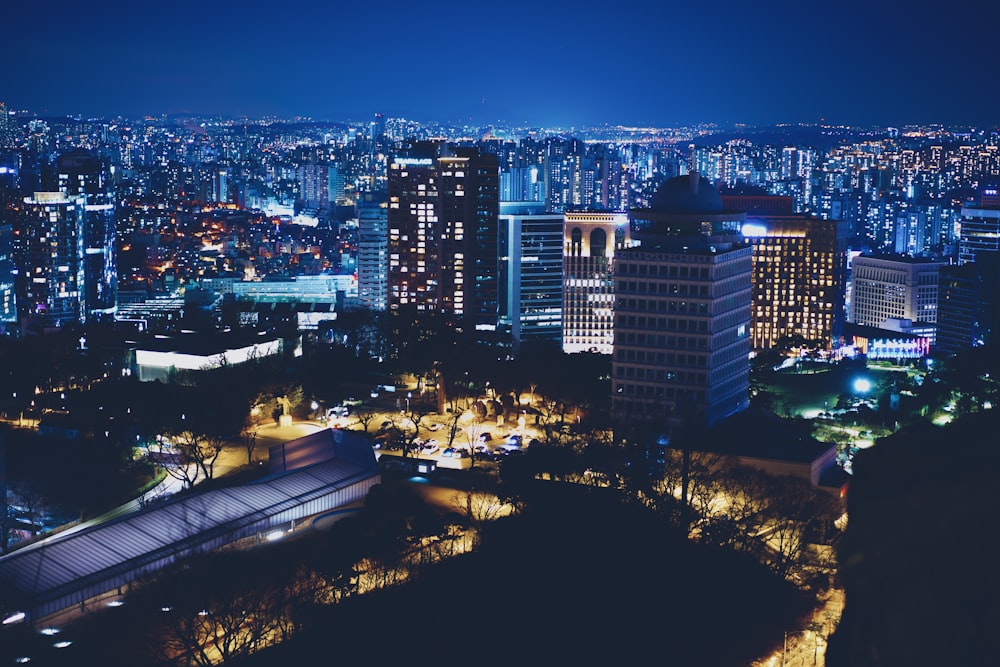 a view of a city at night from the top of a hill