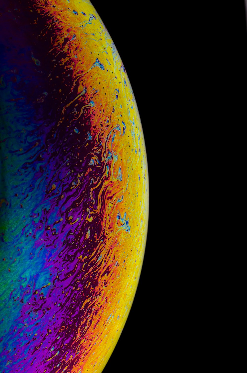 a close up of a colorful object with a black background