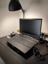 A peaceful workspace with a laptop and a small plant beside it.