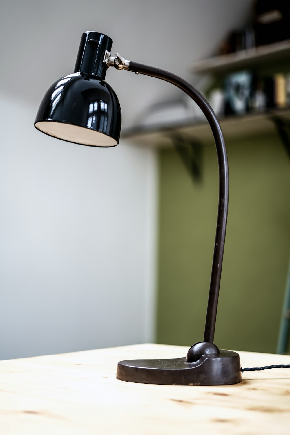 a desk lamp sitting on top of a wooden table