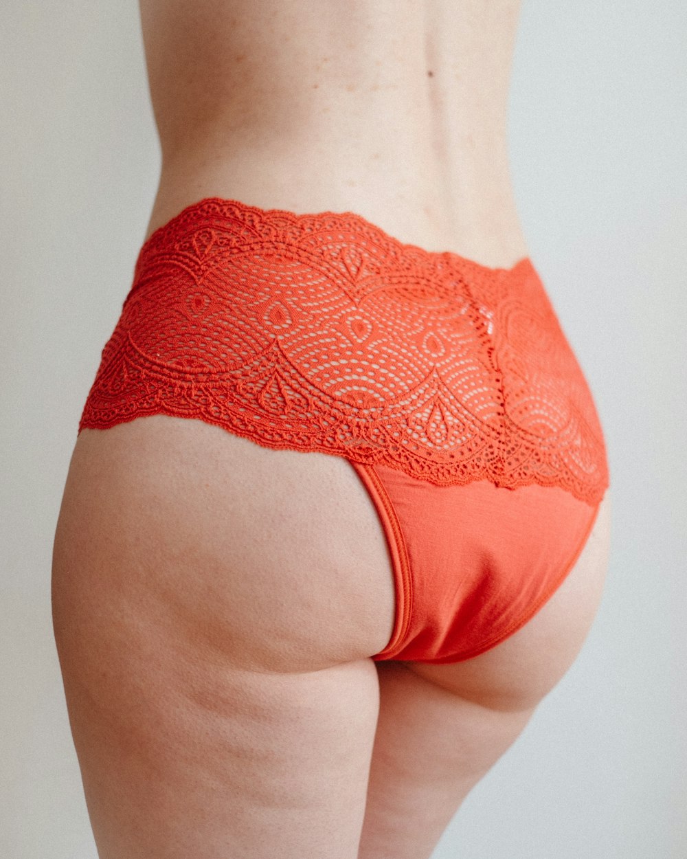 a woman's butt with a lacy orange panties