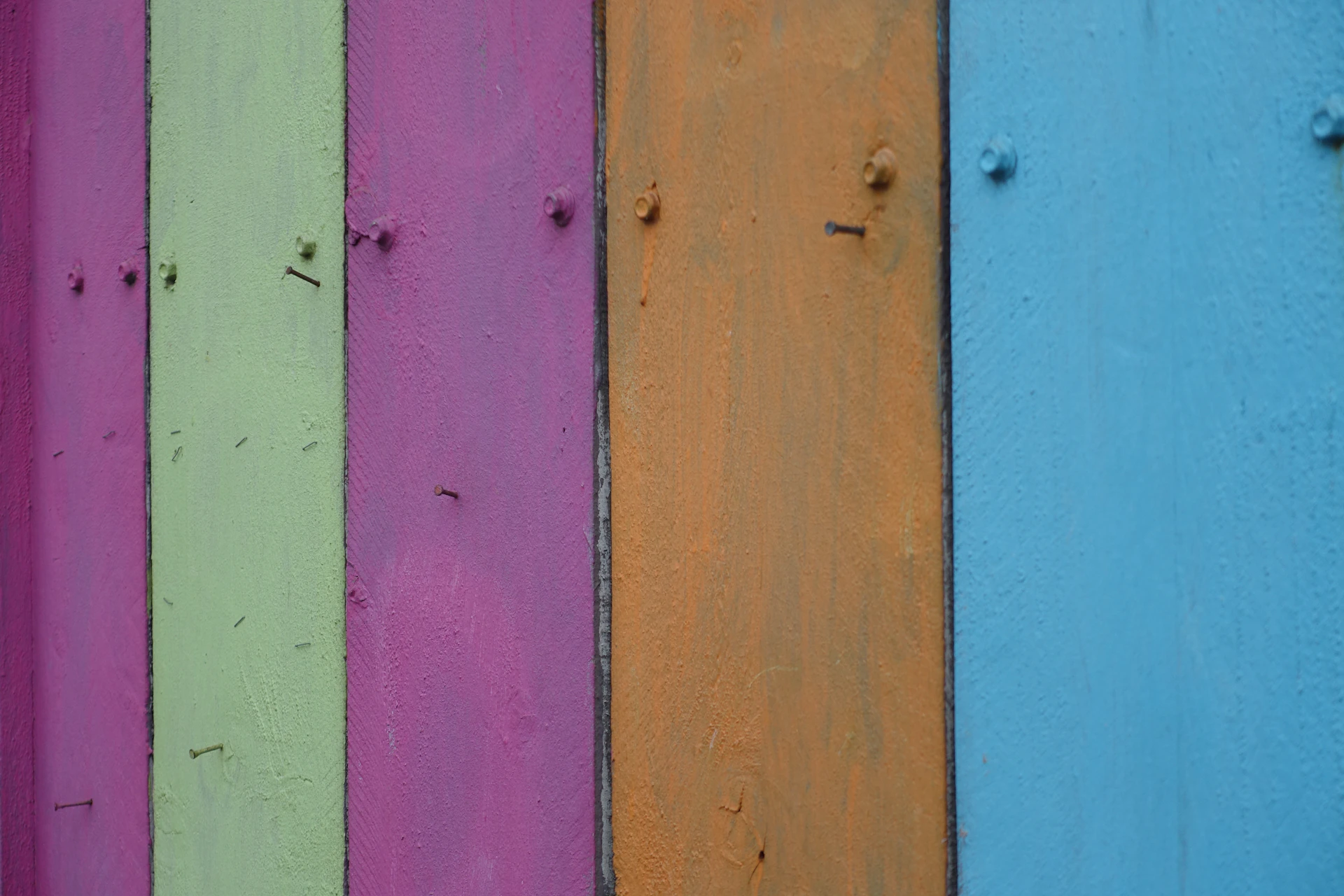 a close up of a multicolored wooden fence