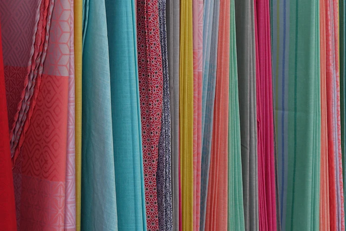 Colourful fabrics hung on a wall