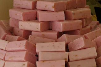 Light pink soap bars stacked like a cake, with tiny soap sprinkles on top.