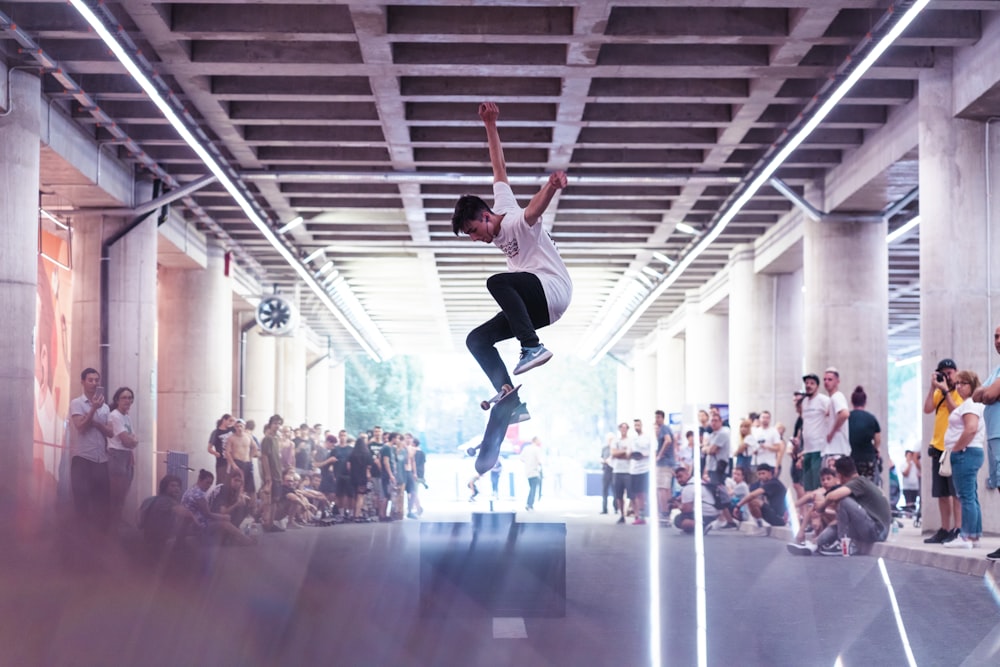 a skateboarder is doing a trick in front of a crowd