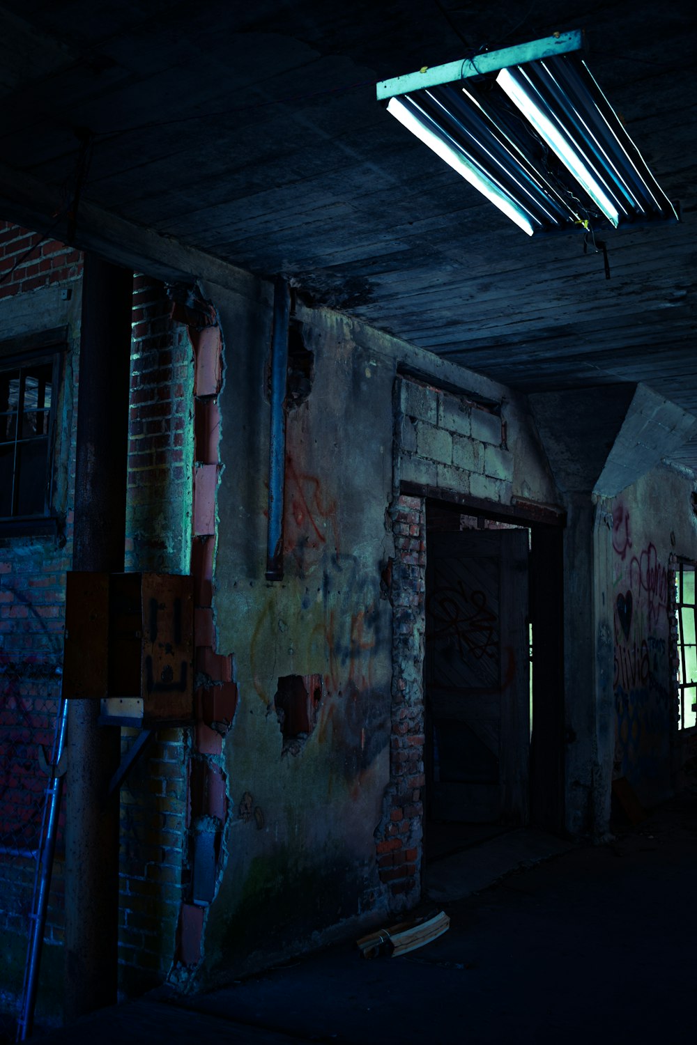 a dark room with graffiti all over the walls