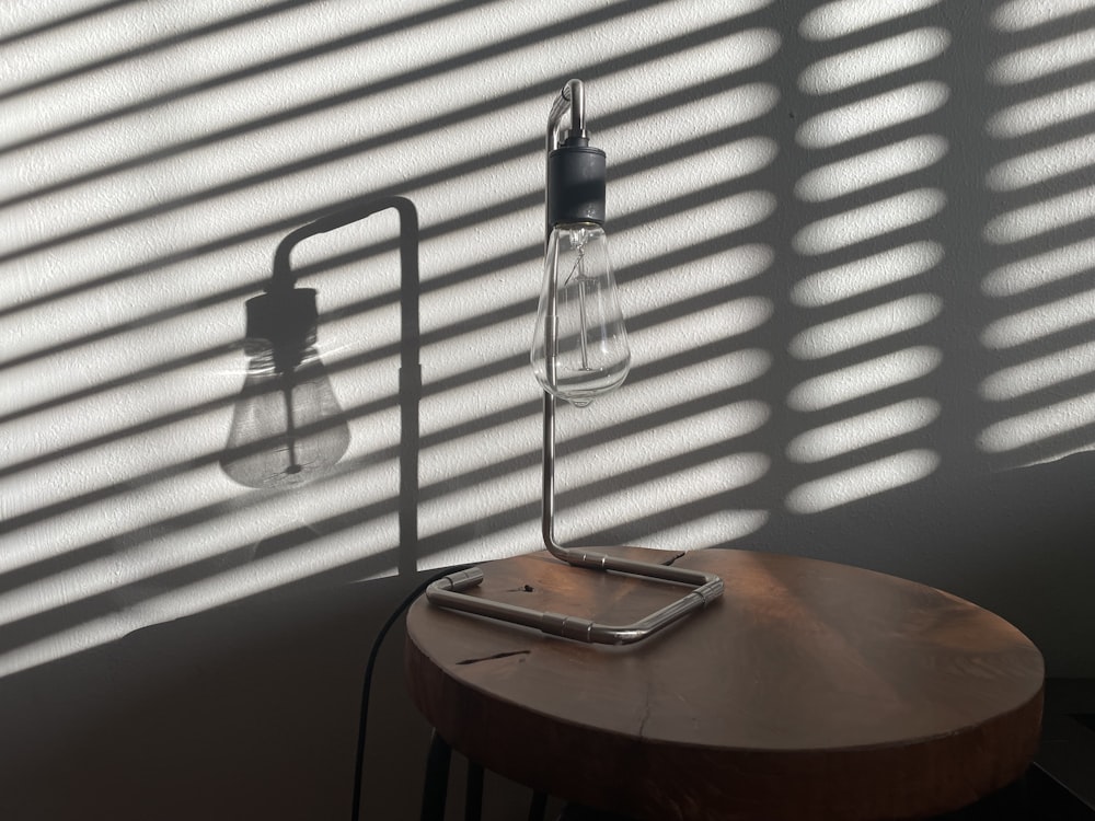 a table with a lamp on top of it next to a window