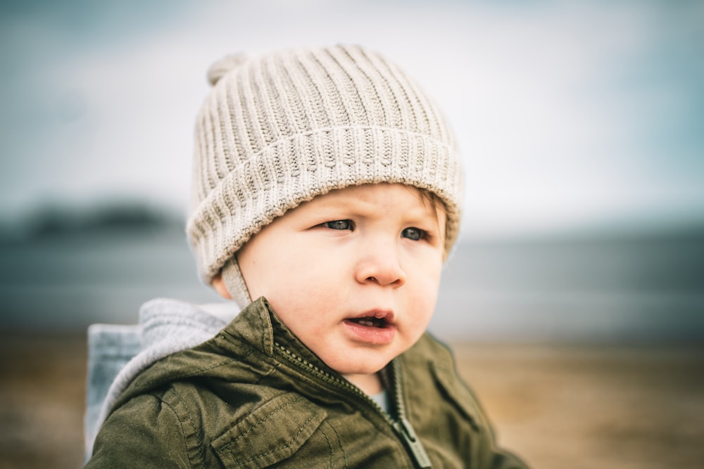 a small child wearing a hat and jacket