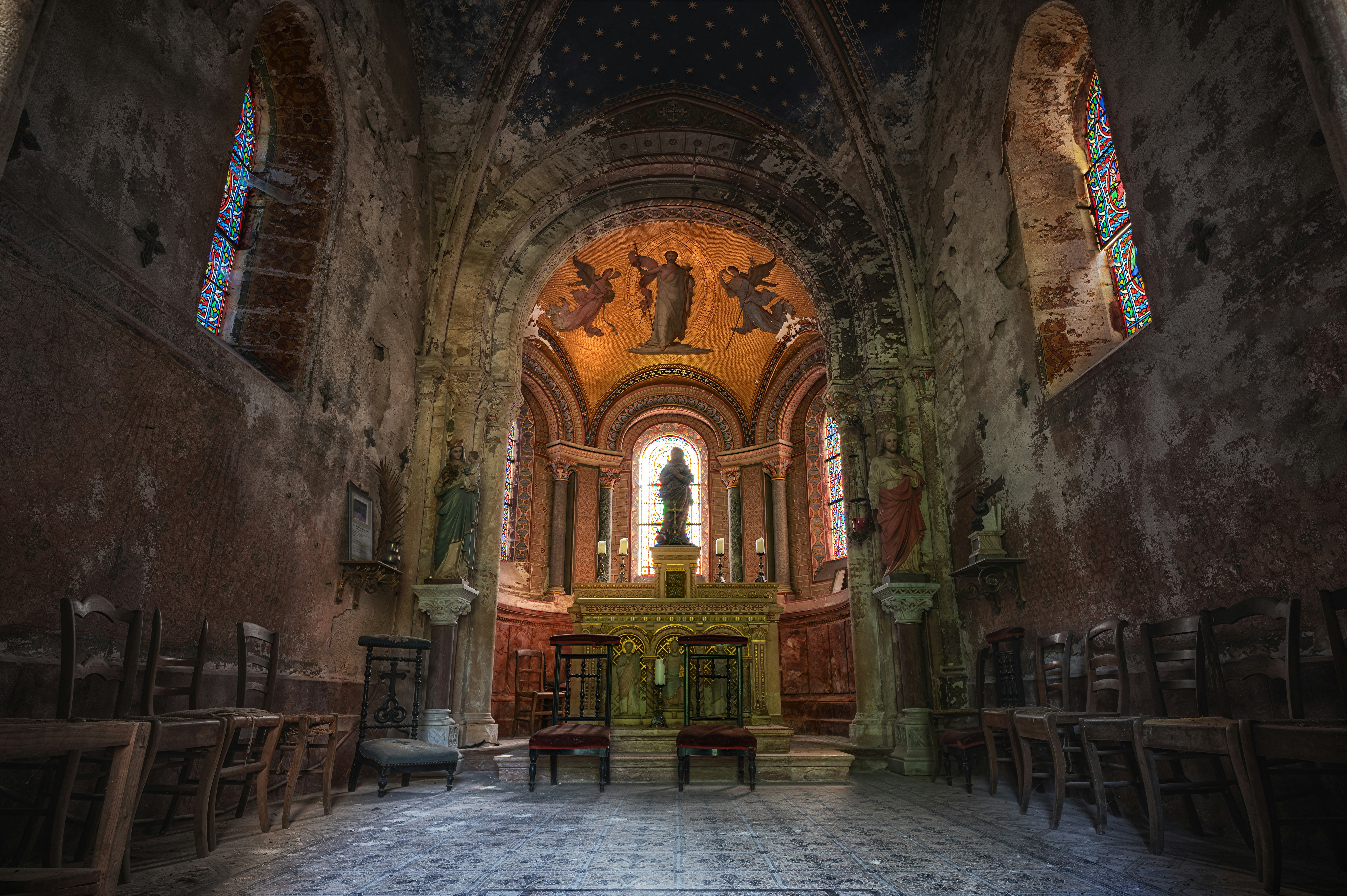 an old church with stained glass windows and pews