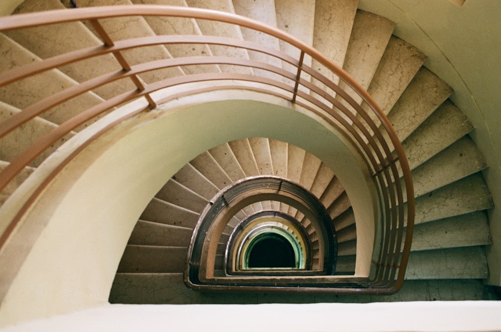 a spiral staircase with a light at the end