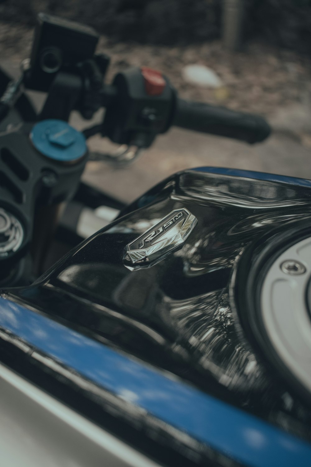 a close up of a motorcycle handlebars with a blurry background