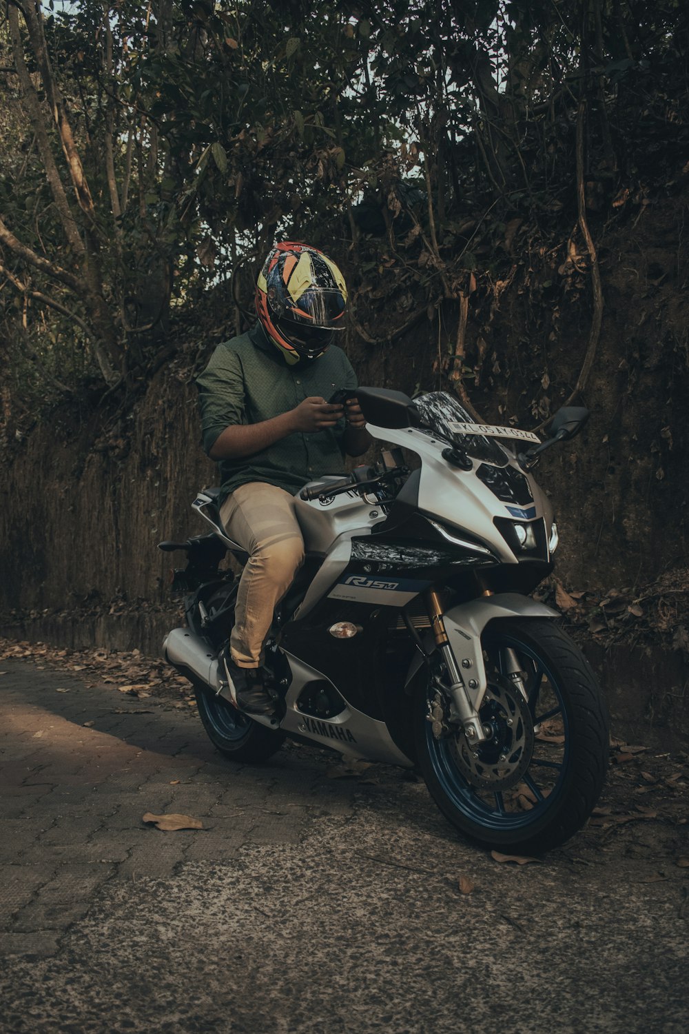 a man sitting on a motorcycle with a helmet on