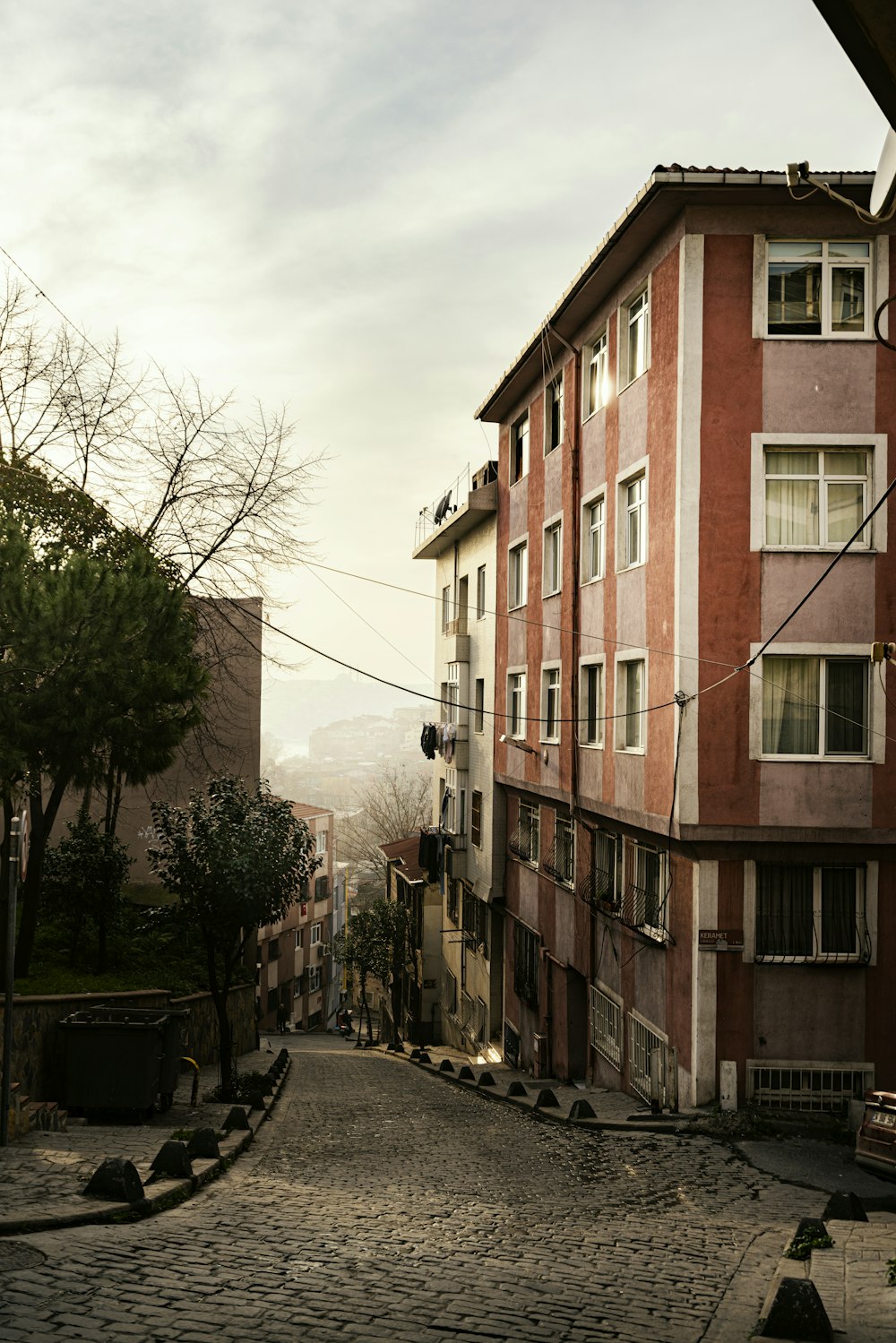 a cobblestone street in front of a brick building