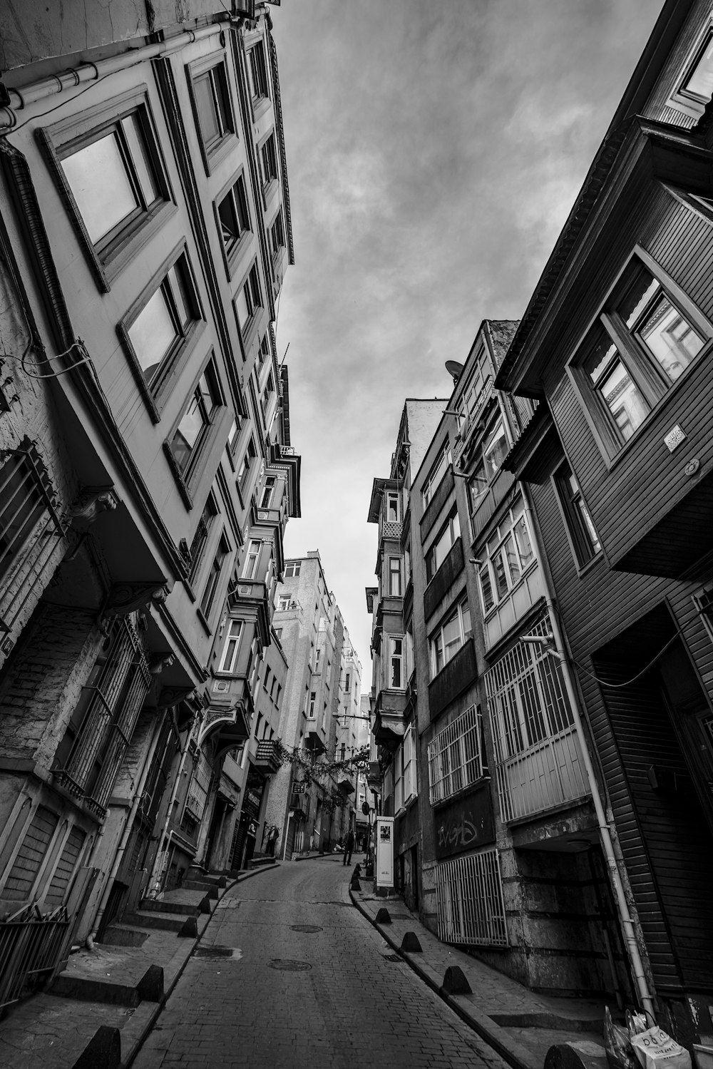 a black and white photo of a narrow street