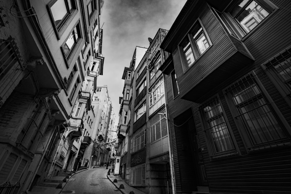 a black and white photo of a narrow street