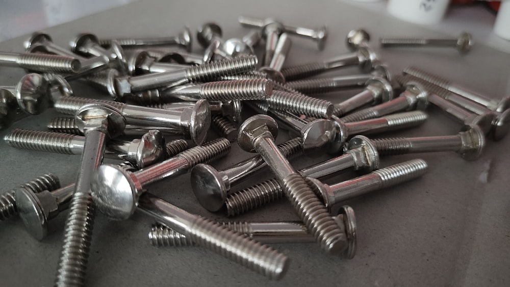 a pile of screws and nuts on a table