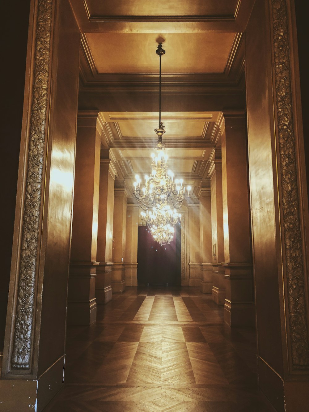 a chandelier hanging from the ceiling of a hallway