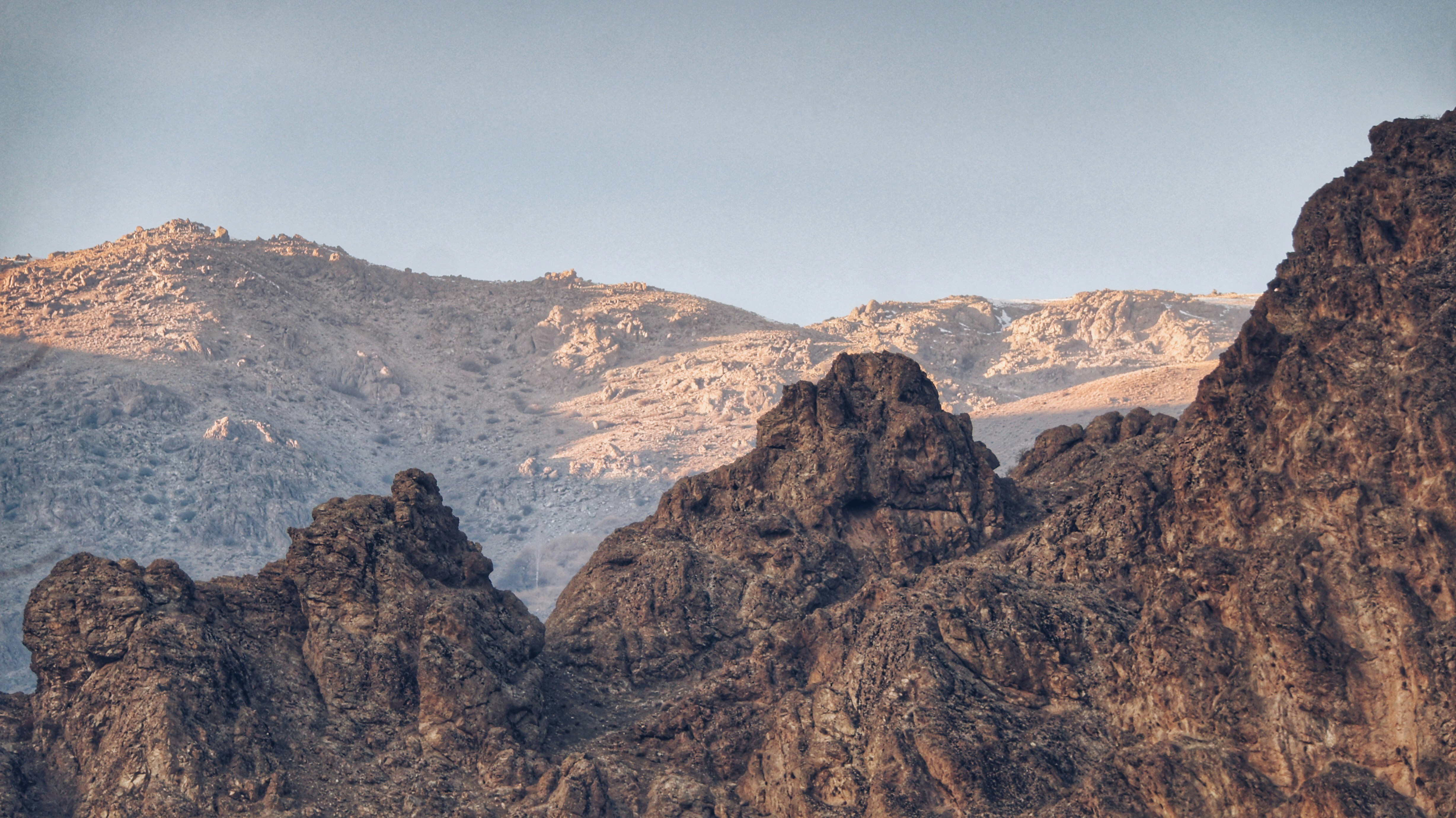 a mountain range with a bird perched on top of it