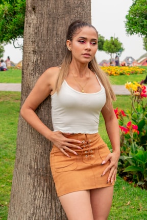A stylish woman wearing a casual yet elegant outfit in a park.