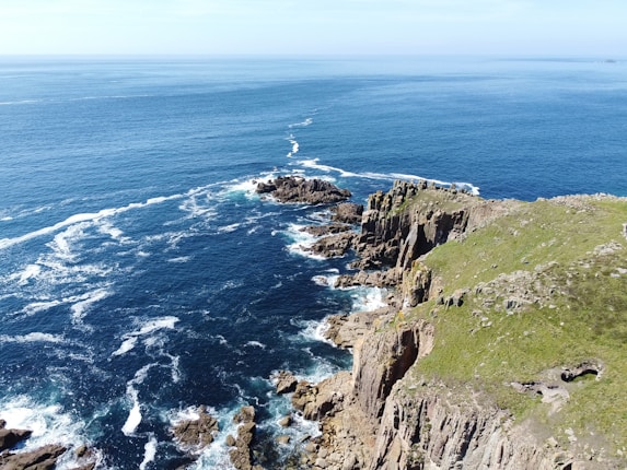 a view of the ocean from the top of a cliff