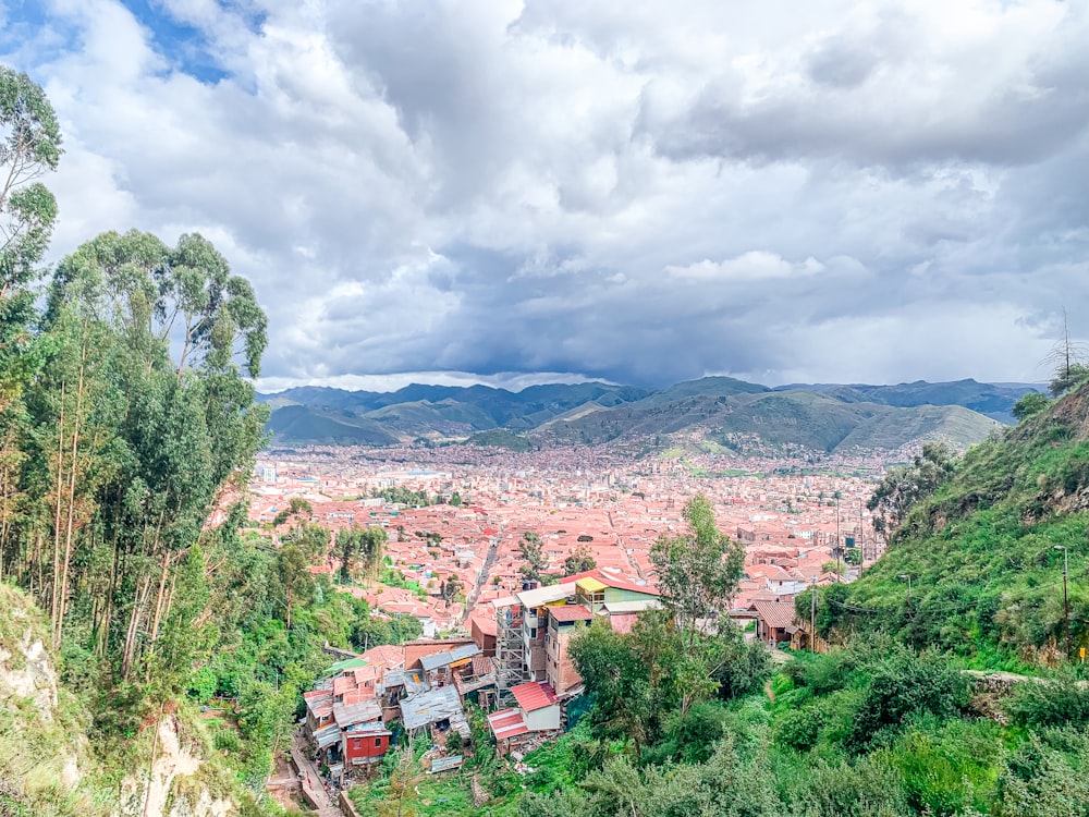 a scenic view of a city surrounded by mountains