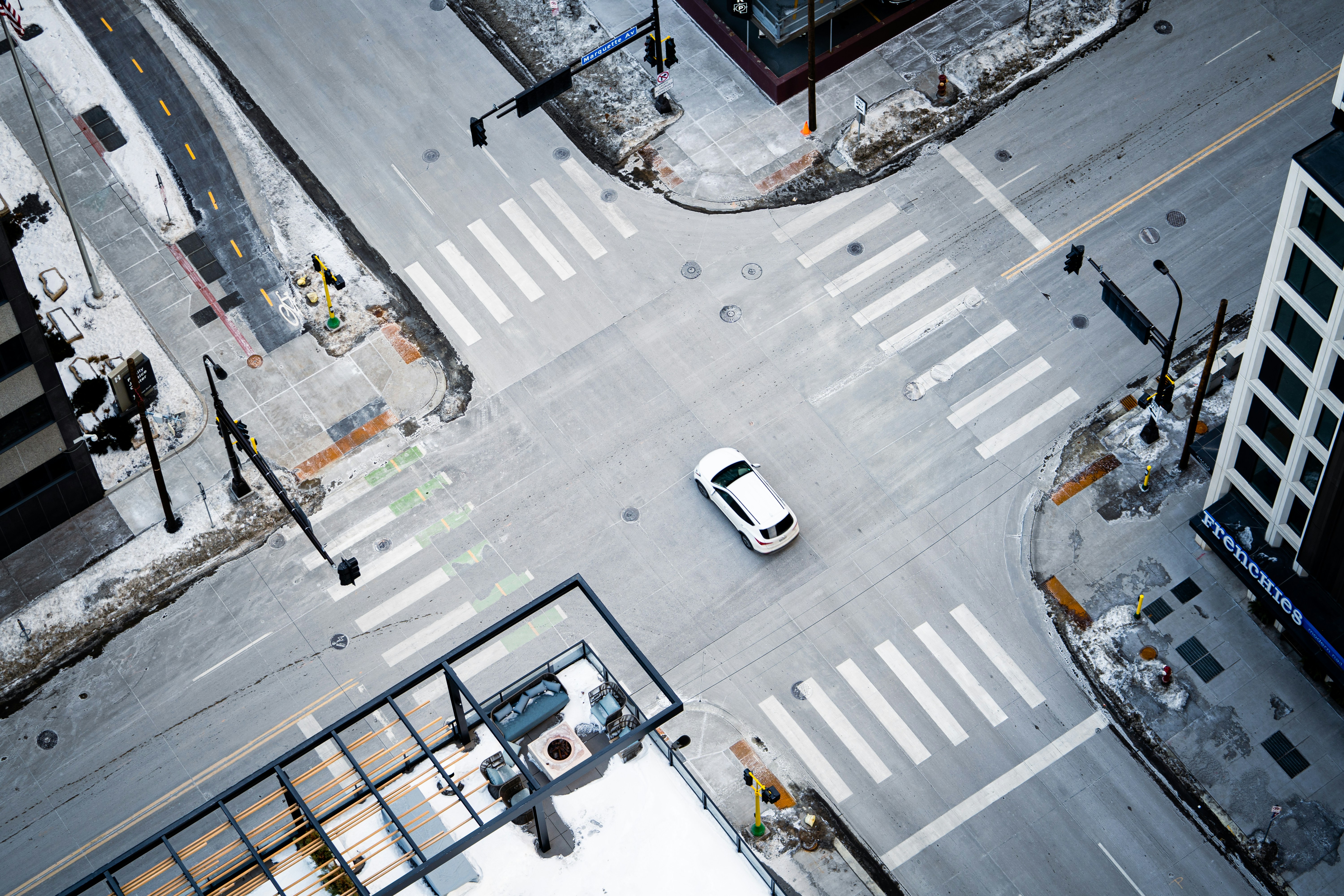 an overhead view of a city intersection with a car, 