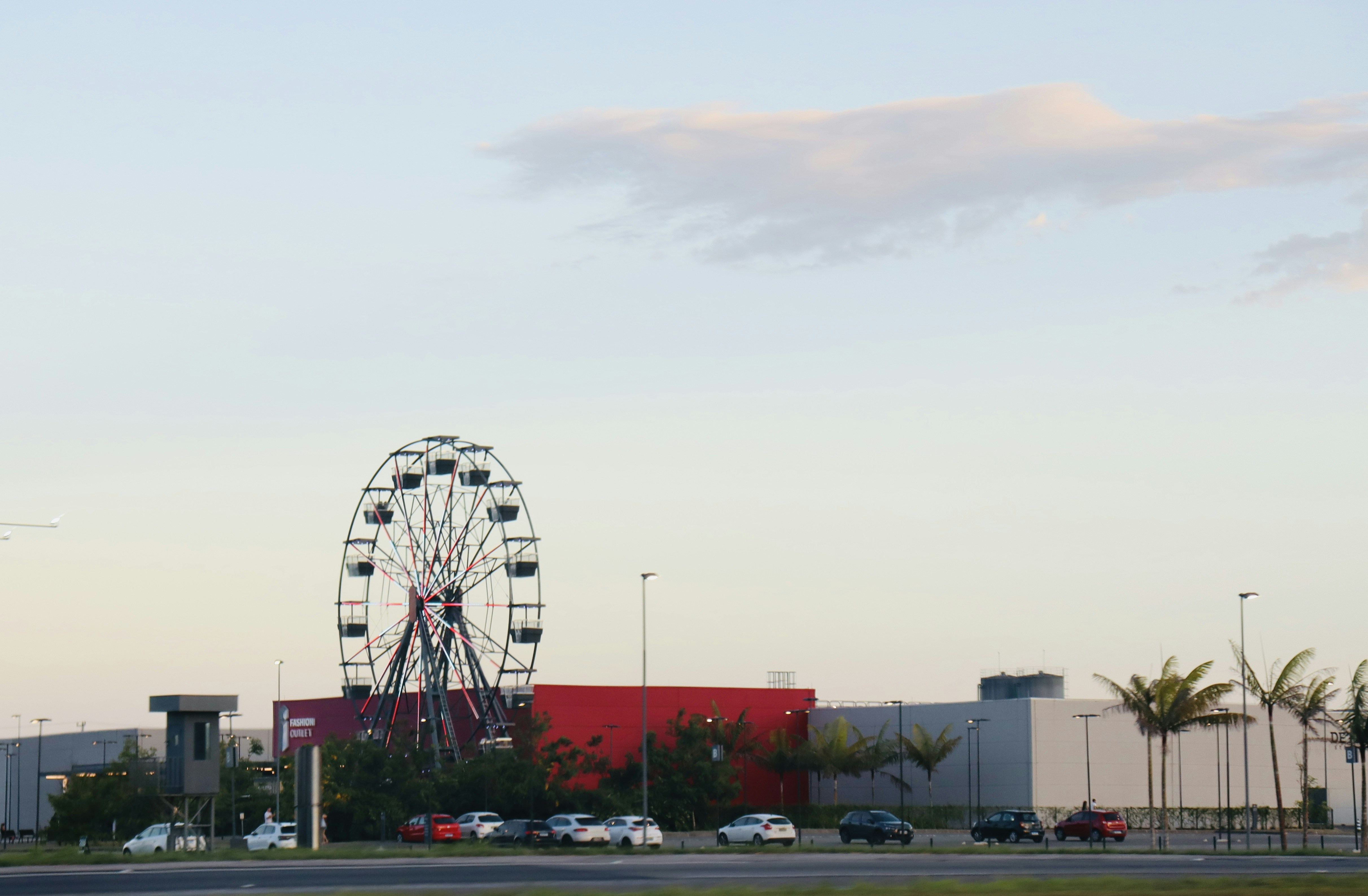 a large ferris wheel sitting next to a parking lot