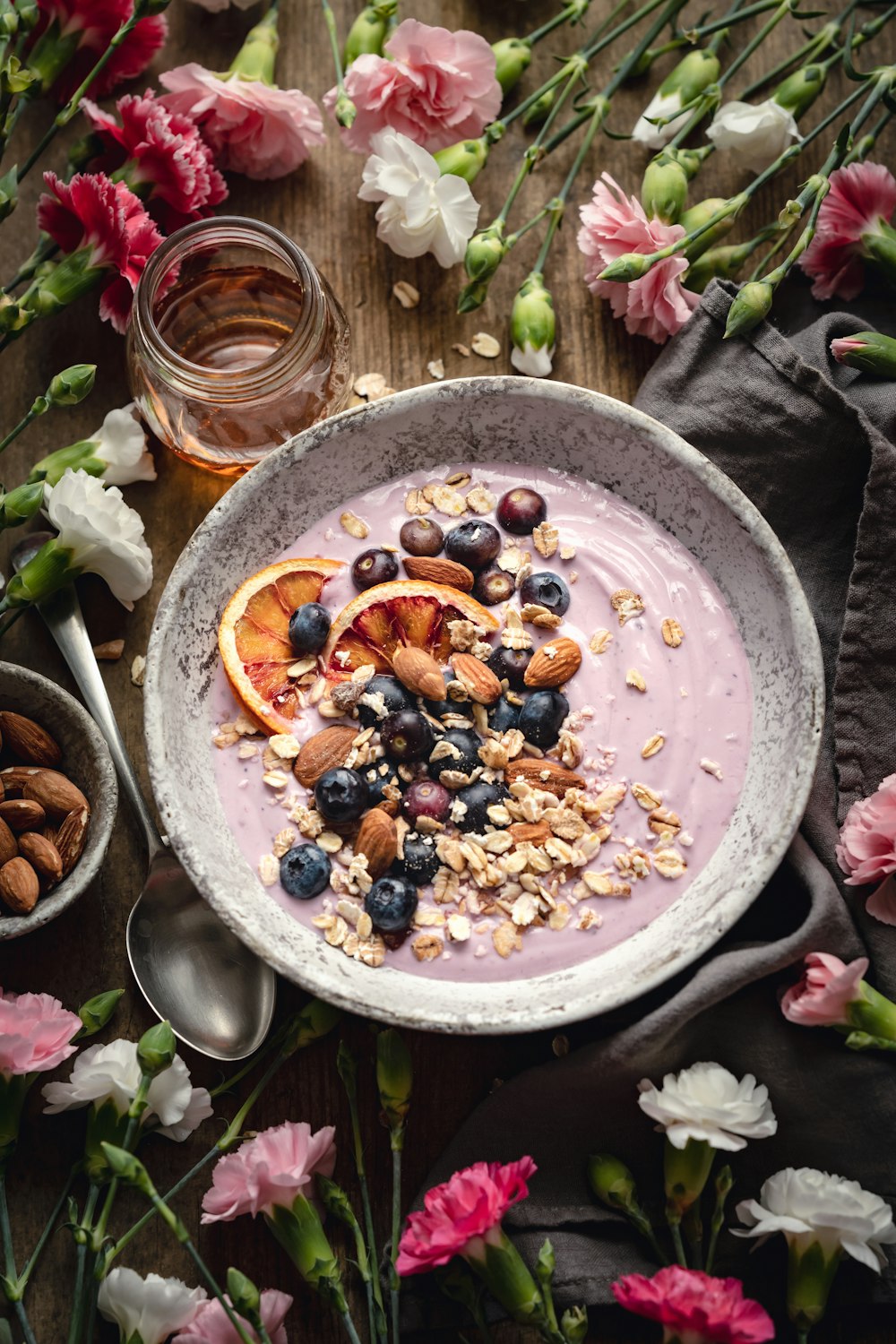 a bowl of oatmeal topped with fruit and nuts