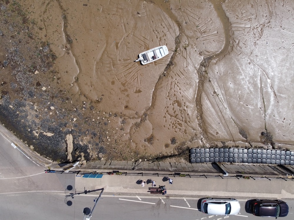 an aerial view of a boat on the beach