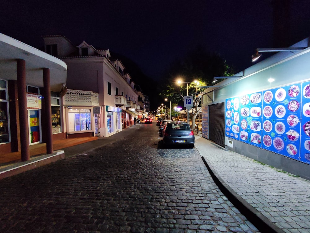 a car parked on the side of a street at night