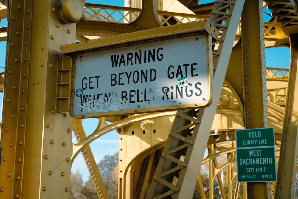 a close up of a street sign on a bridge