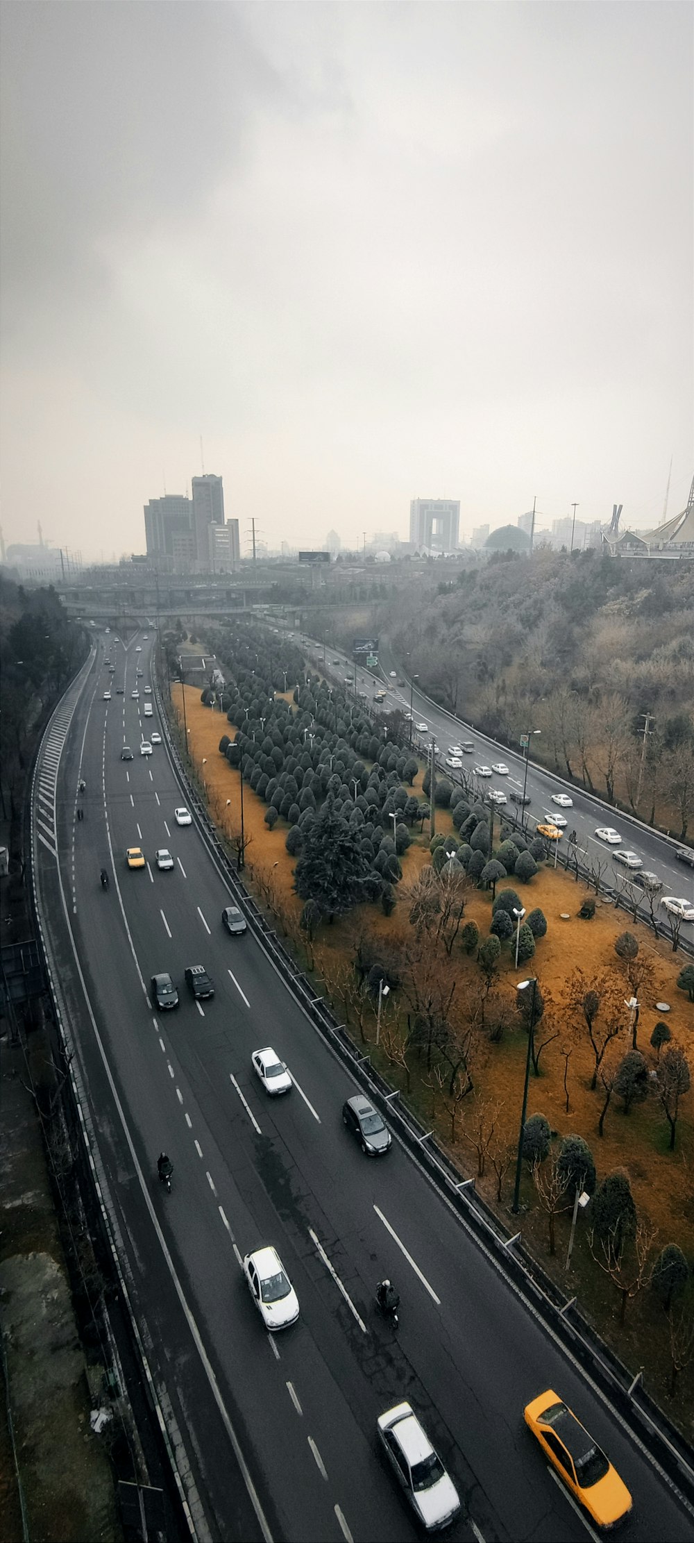 a highway with a bunch of cars driving down it