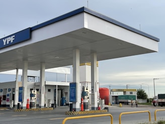 an empty gas station with a sky background