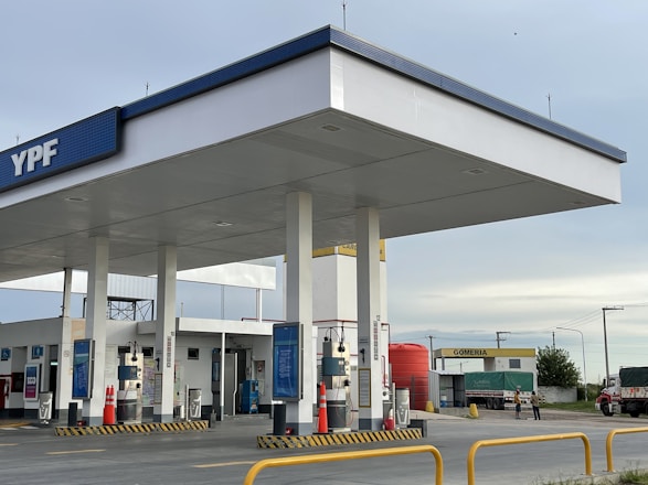an empty gas station with a sky background
