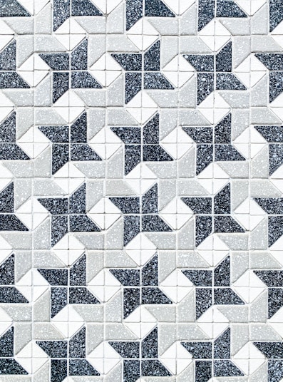 a black and white tiled wall with a pattern of stars