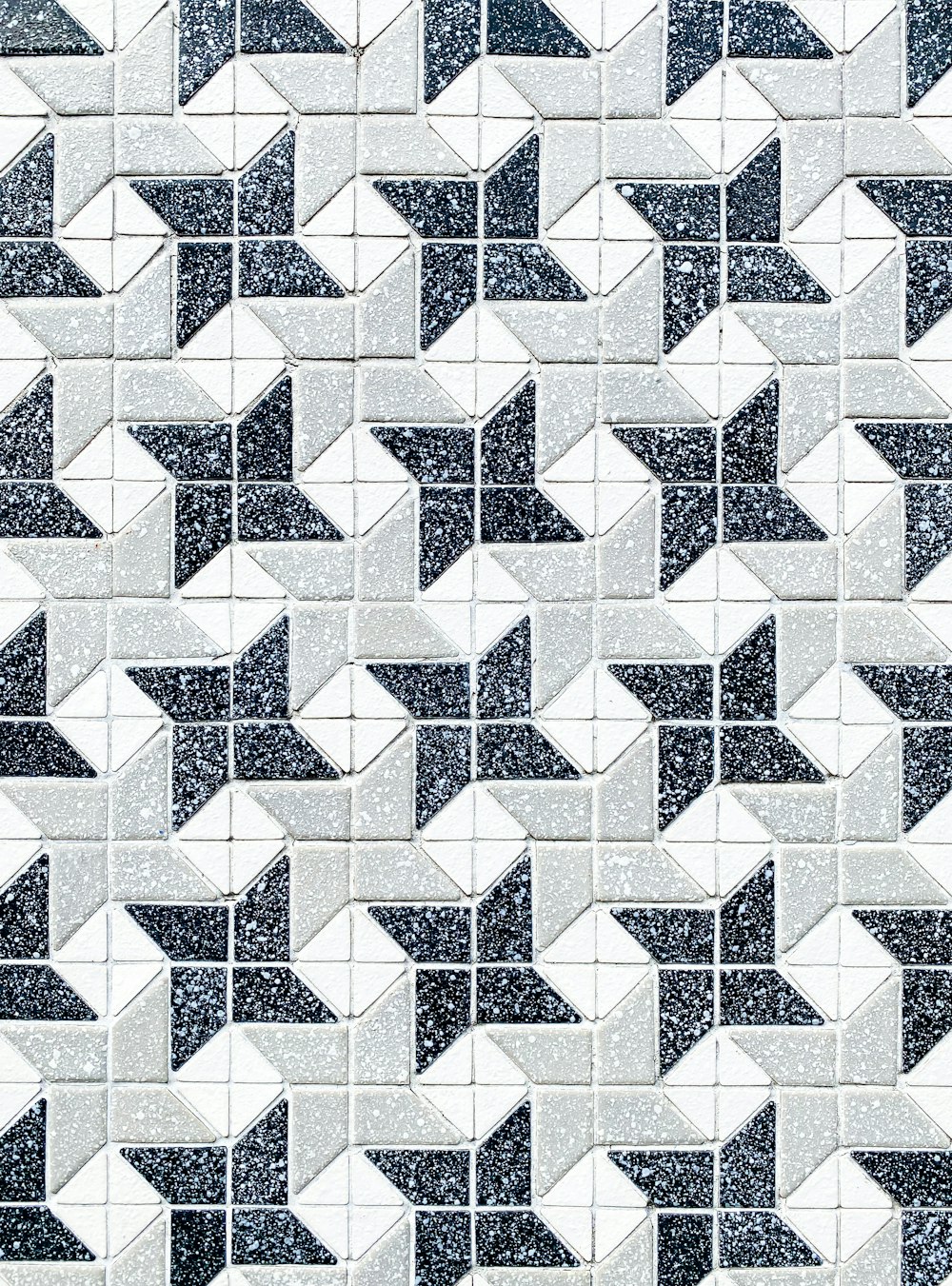 a black and white tiled wall with a pattern of stars