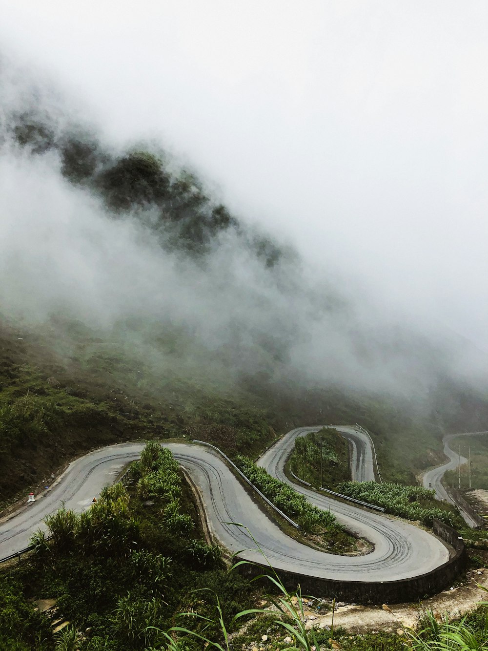 a winding road in the middle of a mountain