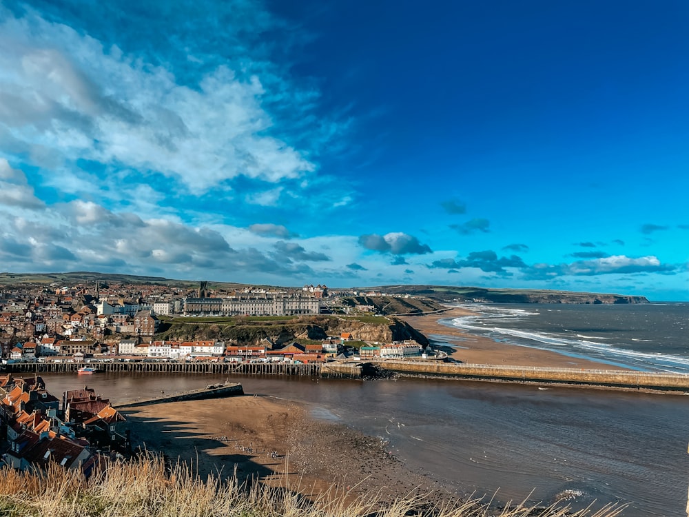 a view of a beach and a city from the top of a hill